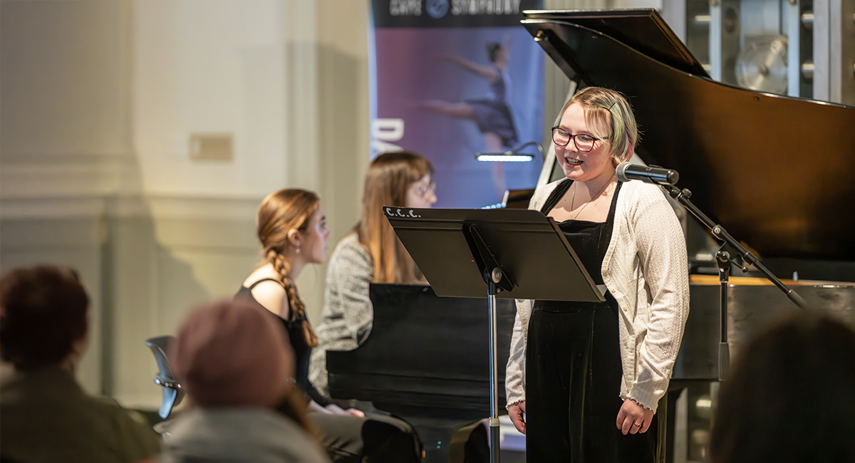 Grace Callahan sings at a recital with piano accompanist